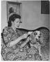 Photograph: [Catherine Nimitz Sits on Couch With Dog]
