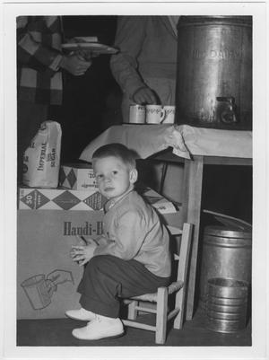 Primary view of object titled '[Child seated at North Texas 1956 Homecoming alumni luncheon]'.