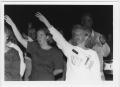 Primary view of [Students singing at North Texas Homecoming bonfire, c. 1990]