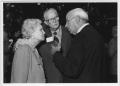 Photograph: [Zeke Martin talks with Mr. and Mrs. Moore at the North Texas Alumni …