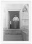 Primary view of [Man Posing in the Doorway of a Church]