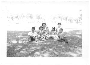 Primary view of object titled '[Hispanic Woman and Children Sitting in the Grass # 1]'.