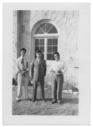 Primary view of object titled '[Three Young Men Standing in Front of a Window Outside]'.