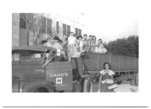 Primary view of object titled '[Girls Standing in the Back of a Farm Truck]'.