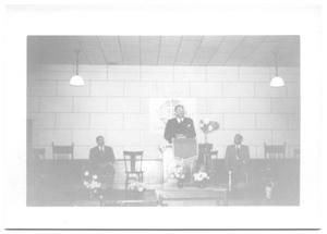 Primary view of object titled '[Reverend Standing Behind a Podium]'.