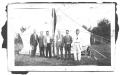Photograph: [Six Gentlemen Standing in Front of a Tent Structure]