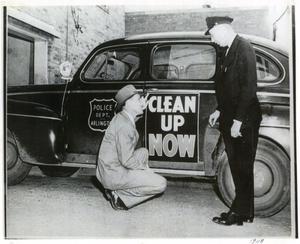 Primary view of object titled '[Arlington Police Commissioner Joe Elder and Fire Chief Mike Thompson, 1948, "Clean Up Now" campaign, date on photo]'.