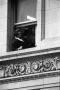 Photograph: [People in a window above Main Street awaiting the president's motorc…