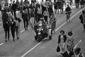 Photograph: [Police motorcycle and the crowd on Main Street]
