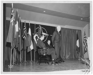 Primary view of object titled '[William Lockhart Clayton with unidentified men on stage with flags]'.