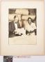 Photograph: [Lamar Fleming, Jr. at cotton facility with unidentified woman]