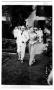 Thumbnail image of item number 1 in: '[Mary Van den Berge Hill walking with unidentified man in white suit]'.