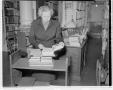 Primary view of [A woman with books at Capital Archives]