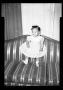 Photograph: [Photograph of a Young Child Standing on a Couch]