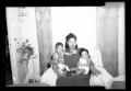 Photograph: [Photograph of a Woman with Two Children]
