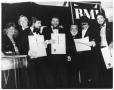 Photograph: [Photograph of Bill Hall Standing Behind People at a BMI Event]