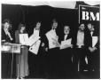 Primary view of [Photograph of Bill Hall In a Row of People at a BMI Event]