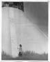 Photograph: [Woman at Base of Lighthouse]