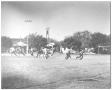 Photograph: [Photograph of Teen Boys Playing Football in a Park]