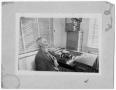 Photograph: [Portrait of man in an office]