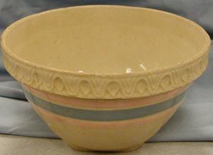 Primary view of object titled 'large bowl, yellow inside, orange and blue stripes on outside'.