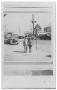 Primary view of [Boy and girl in front of street with Texaco Station]