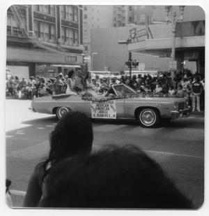 Primary view of object titled '[Decorated car with banner in Fiestas Patrias parade]'.