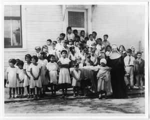 Primary view of object titled '[Children receiving clothes for school]'.