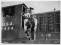 Photograph: [Two men on a train engine]