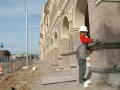 Primary view of [Workman smooths cement on the front of the new Fort Worth Mercado building]
