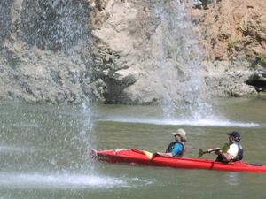 Primary view of object titled '[Two people in a kayak approach a double waterfall]'.