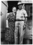 Photograph: [Dagny and Andrew Jensen in Front of their Home]