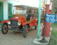 Primary view of [Antique car and gasoline pump]