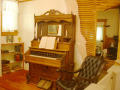 Primary view of [Musical instrument, bookshelves with books, and furniture]