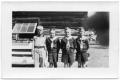 Photograph: [Four Boy Scouts in Front of Log Cabin]