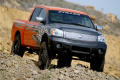 Primary view of [Black and orange Nissan truck on hill]