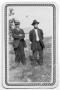 Photograph: [Two Men in Hats Standing in a Field]