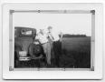 Photograph: [Two Men Posed Next to a Model A Ford]