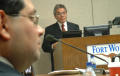 Primary view of [Jose Legaspi standing behind podium with computer monitor]