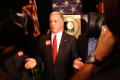 Primary view of [Howard Dean gesturing in front of NALEO seal]