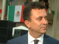 Thumbnail image of item number 1 in: '[Carlos Garcia de Alba close-up with Mexican flags in background]'.