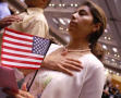 Primary view of [Woman holds flag while saying the Pledge of Allegiance]