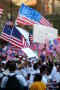 Photograph: [Protesters waving signs and American flags]