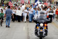 Thumbnail image of item number 1 in: '[Group of Protesters Walking Behind Police Officer on Motorcycle]'.