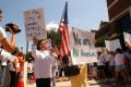 Thumbnail image of item number 1 in: '[Protesters walk in a circle with signs, "Is the city of Farmers Branch racist?" and "We are all Americans"]'.