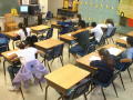 Thumbnail image of item number 1 in: '[Empty desks reveal the number of absent students in a classroom]'.