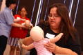 Thumbnail image of item number 1 in: '[Mothers use dolls to help in first aid training]'.