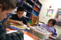 Primary view of [Students concentrate on their drawings at Crockett Elementary]
