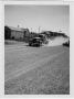 Photograph: [U.S. Highway 79 Car traveling on untreated gravel]