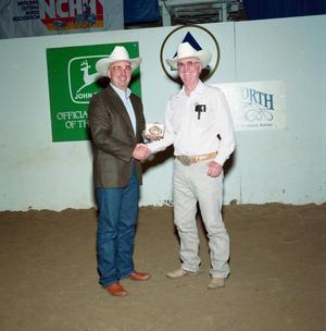 Primary view of object titled '[Two men in an award presentation at Will Rogers Coliseum]'.